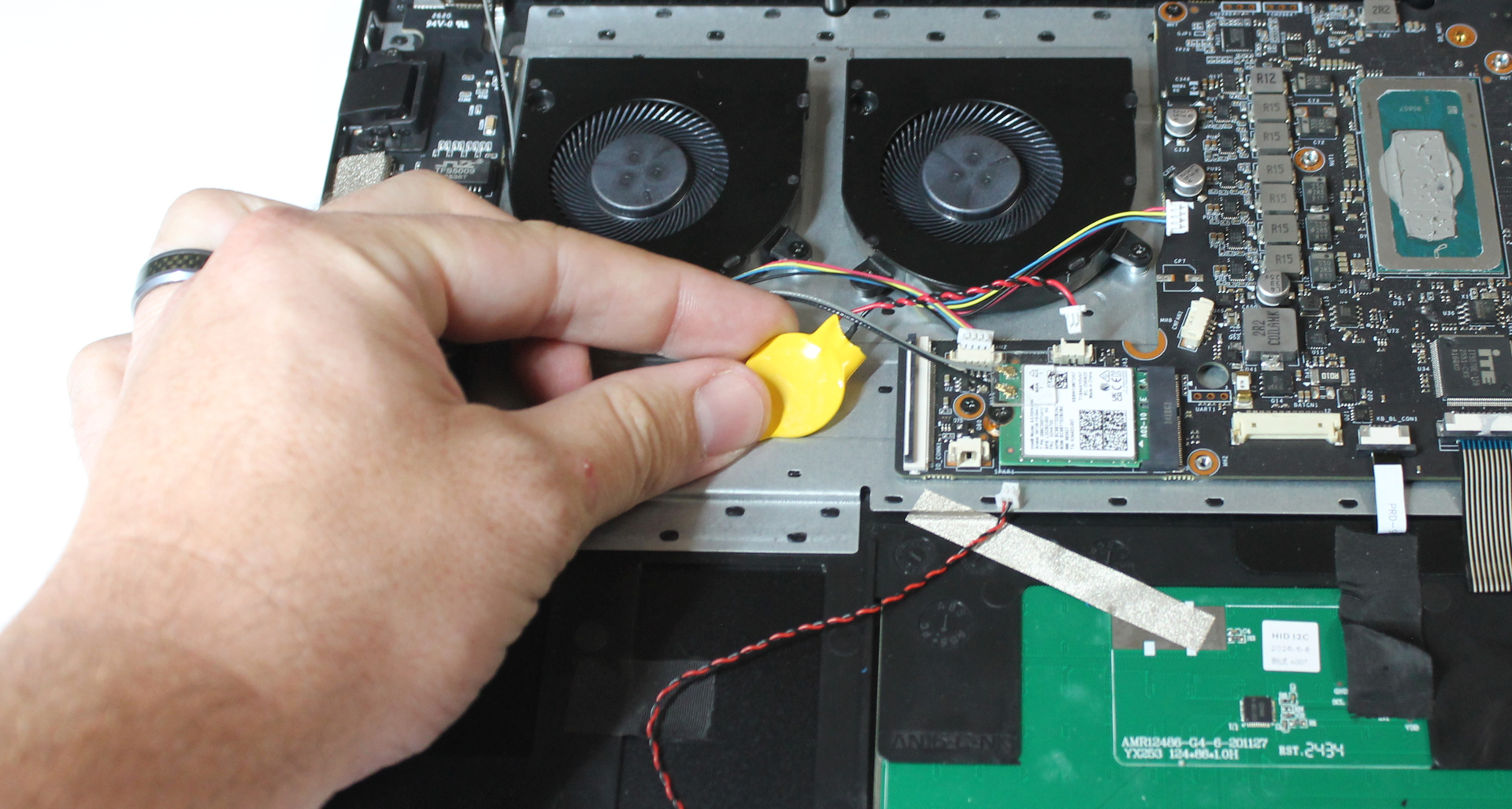 Coin cell in position to stick to chassis