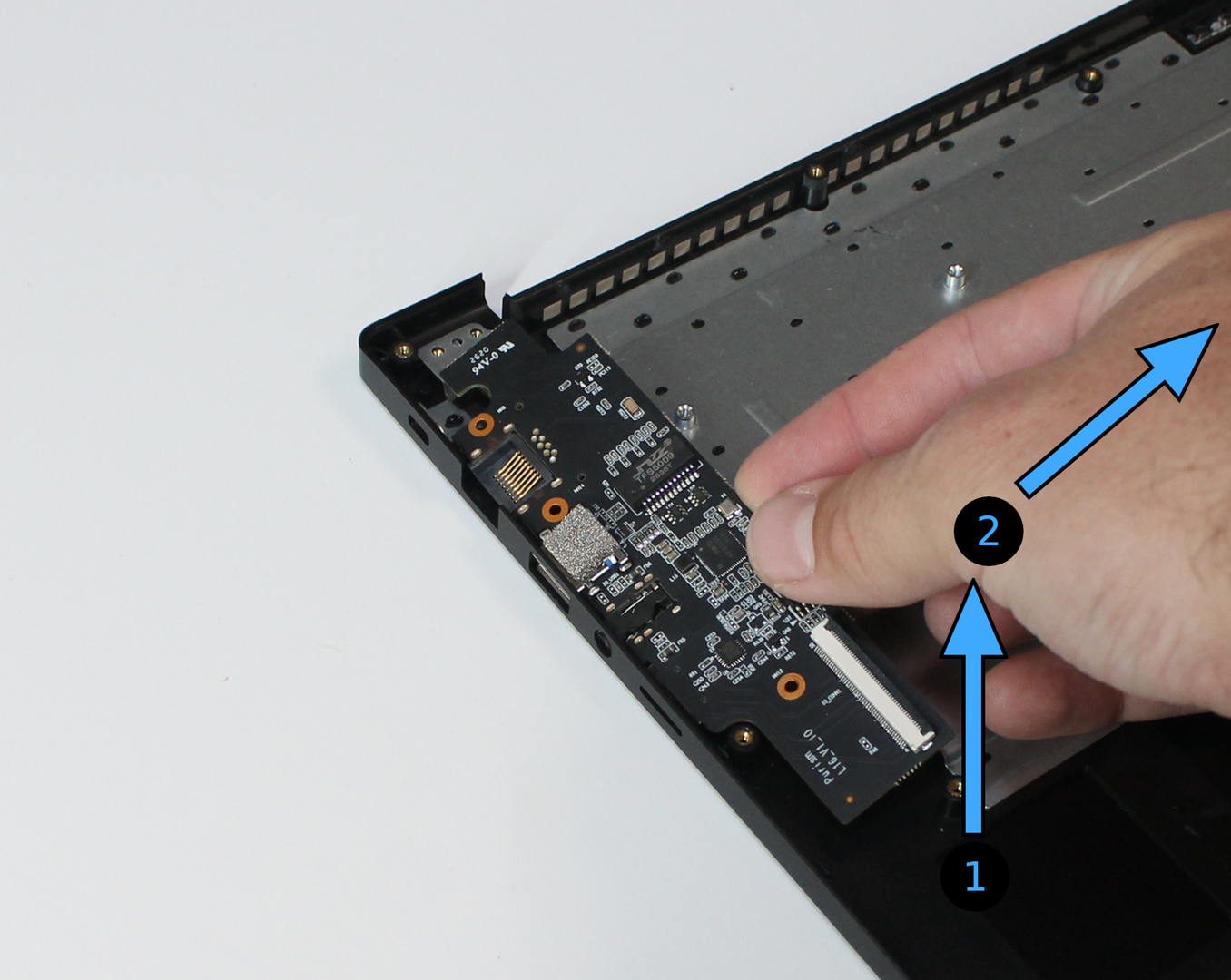 I/O board lifted to remove, with removal directions marked