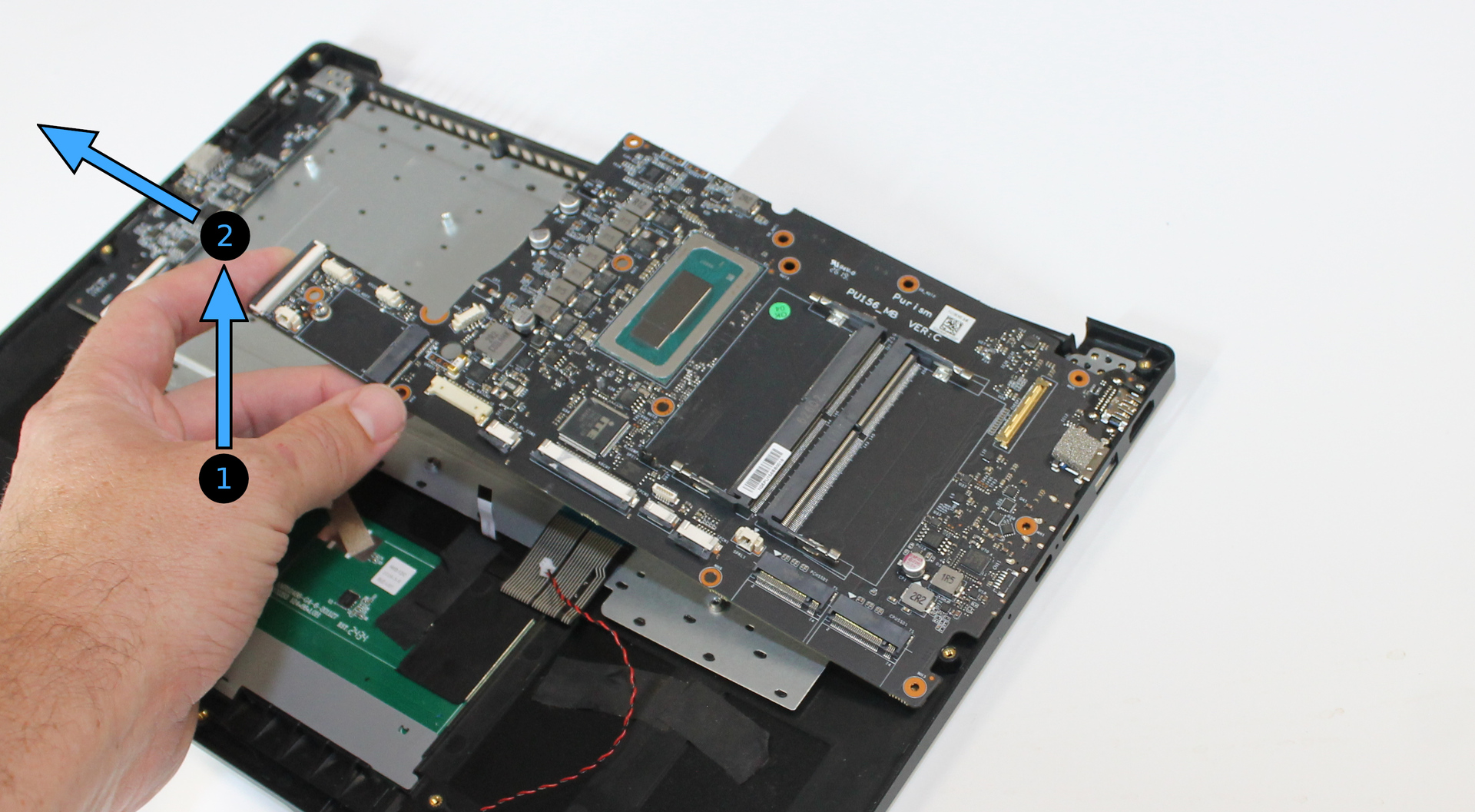 Mainboard lifted to remove, with remove direction indicated