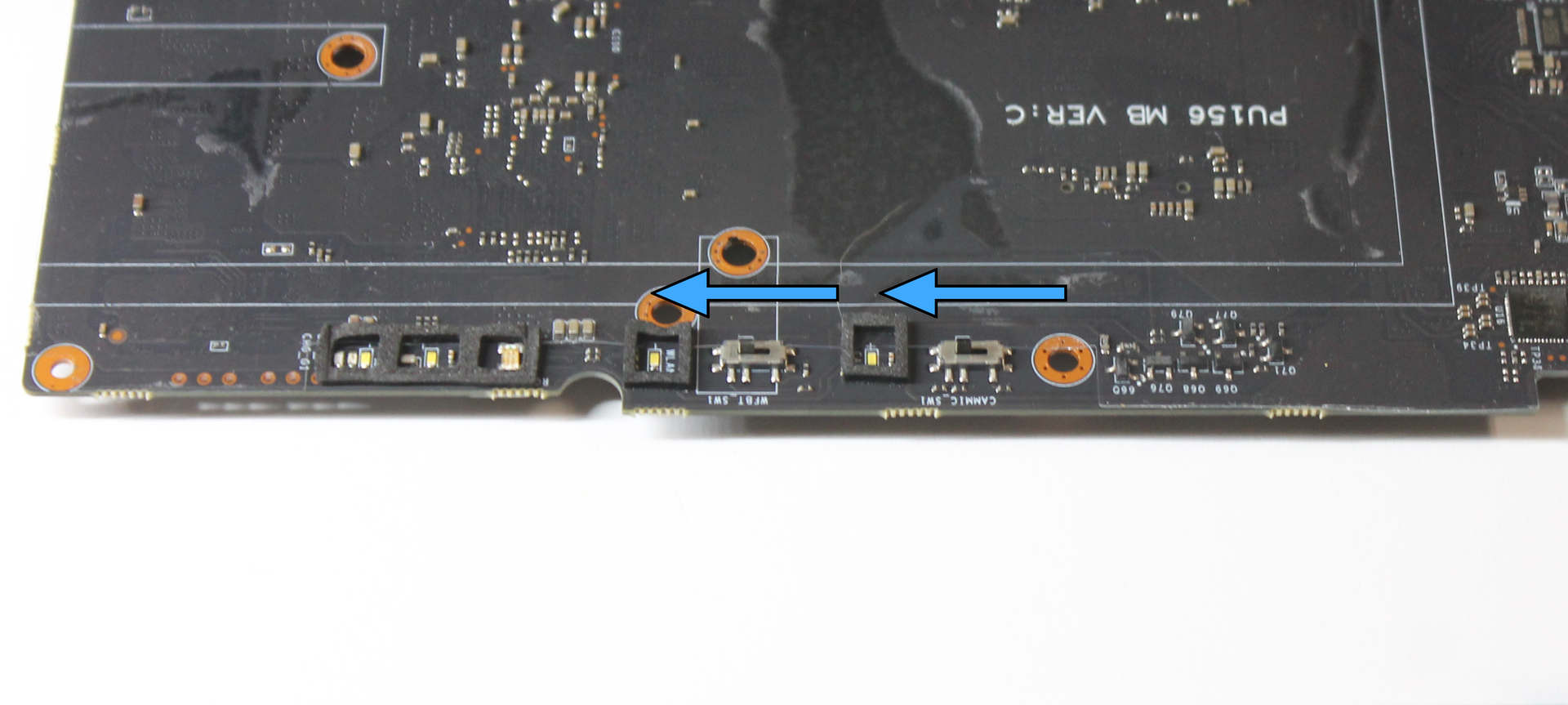 Mainboard kill switches in position to align with caps, slide direction indicated