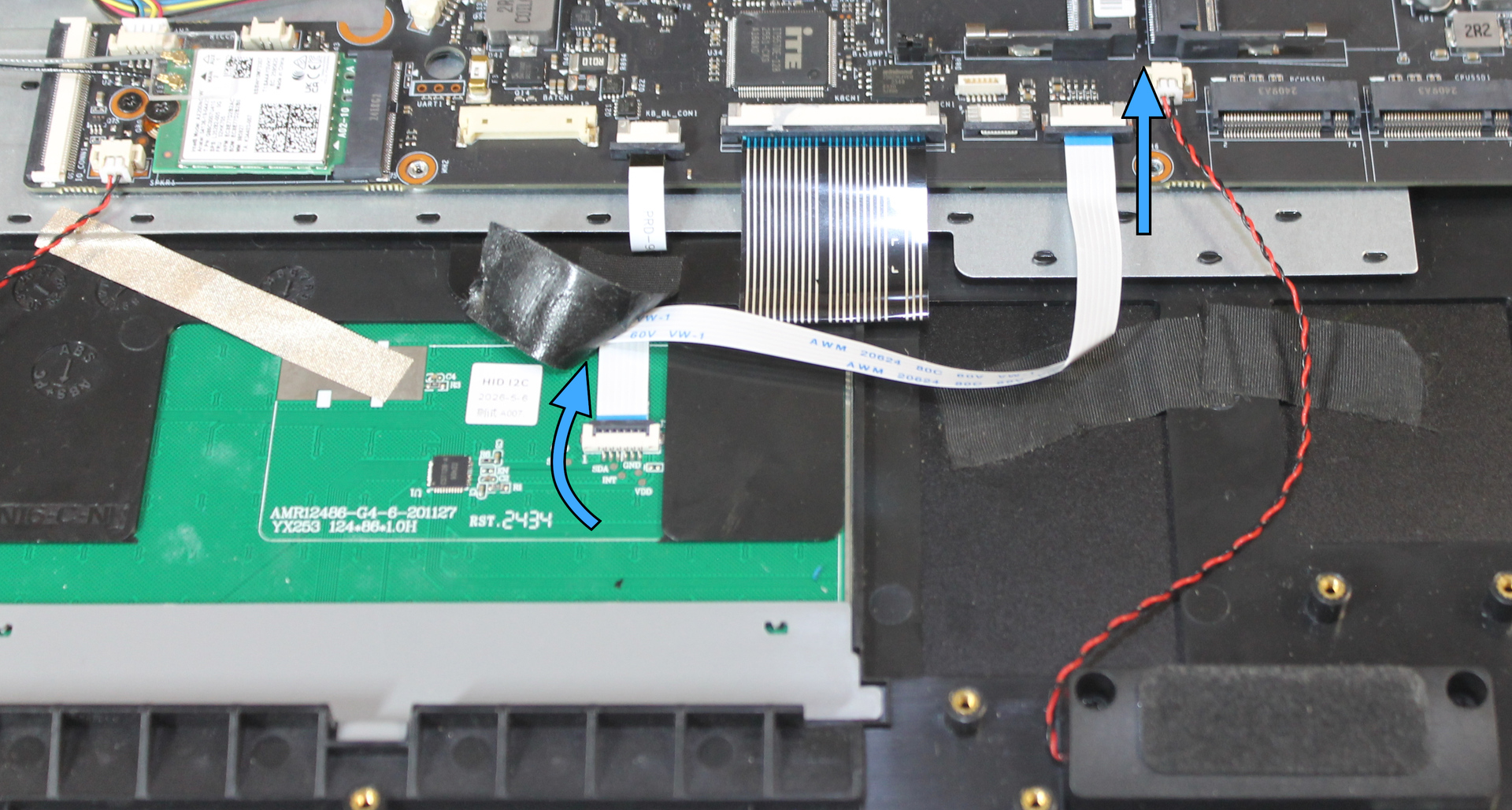 Touchpad cable connectors, with movement directions indicated to secure each